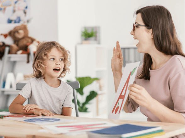 speech pathologist holding up letter